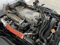 A detailed view of the engine compartment of a 2022 Isuzu NPR showing various hoses pipes and components with a focus on the engine block and intake manifold