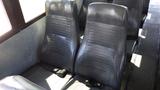 Interior seating of a 2014 Freightliner Thomas Bus Diesel featuring two black vinyl passenger seats