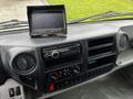 Dashboard of a 2019 Hino 195 featuring a digital display screen and various control knobs including audio and climate controls