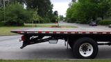 A 2008 Ford F-750 flatbed truck parked on the street with a visible flatbed and rear wheel assembly