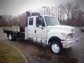 A white 2015 International TerraStar truck with a flatbed and chrome accents parked on a street