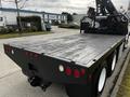 A 2006 Freightliner M2 112 with a flatbed body and visible rear lights showcasing a sturdy and industrial design