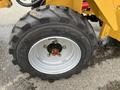 Close-up of a tire on a 2024 AGT Industrial KRW23 Mini Loader featuring a rugged tread pattern and a silver rim with lug nuts visible