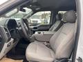 Interior view of a 2019 Ford F-150 showing the driver's seat and center console with grey fabric upholstery