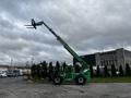 A green 2014 JLG 10054 telehandler with an extended boom and a fork attachment positioned to lift heavy loads