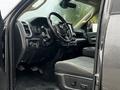 Interior of a 2020 RAM 3500 showing the steering wheel dashboard and seating area with controls and a gear shift