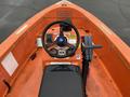 Top view of a 2008 Fassmer 20 Foot Fast Rescue boat featuring an orange interior steering wheel controls and various gauges on the console