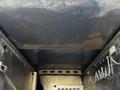 The interior ceiling of a 2018 Ford F-550 showing a metal surface with scratches and marks