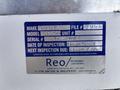 A blue inspection sticker on a Ford F-550 showing various details including make model serial number inspection date and a contact information for an engineering company