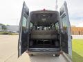 The image shows the open rear doors of a 2019 Mercedes-Benz Sprinter revealing a spacious interior with black seating and a flat loading area