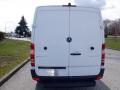 A 2016 Mercedes-Benz Sprinter van viewed from the rear with a white exterior and the Mercedes-Benz logo visible on the hatch door