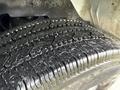 A close-up view of a tire from a 2014 GMC Savana showing the tread pattern and surface details