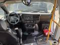 Interior view of a 2018 Chevrolet Express showing the driver's seat steering wheel and dashboard controls