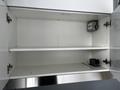 A 40 foot custom climate controlled storage container with a white interior featuring built-in shelves and electrical components mounted on the wall