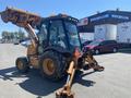 A 2008 Case Super 580M backhoe loader with a yellow and brown exterior featuring a front loader bucket and rear excavator arm