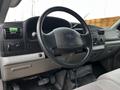 Interior view of a 2007 Ford F-550 showing the steering wheel dashboard and controls with a green item on the steering column