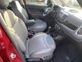 Interior view of a 2015 Fiat 500L with gray leather seats and a modern dashboard featuring a central display and various controls