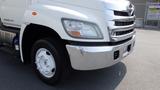 A 2013 Hino 268 truck featuring a white cab with chrome grille and bumper and a single wheel on the front side