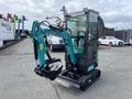 A 2024 AGT Industrial Green QH13R Mini Excavator with a blue-green arm and a bucket attachment positioned in a working stance