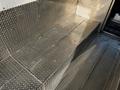 Metal steps with a diamond plate pattern in a Freightliner M Line truck interior