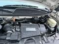 A close-up view of the engine compartment of a 2017 Chevrolet Express showcasing various components including the air intake and reservoir tank