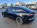 A black 2019 Tesla Model 3 parked with a sleek design and tinted windows showcasing its modern electric vehicle features