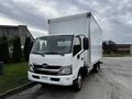 A 2018 Hino 195 truck with a white box cargo body and a cab featuring a sleek design and large windshield