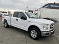 A 2017 Ford F-150 in white with a crew cab design featuring chrome accents and all-terrain tires displayed at an angle