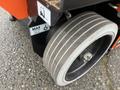 Close-up of a wheel from a 2024 JLG R1932 lift featuring a groove design and labeled with maximum load information