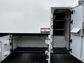 A 2013 Ford F-650 with two open doors revealing interior storage compartments
