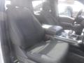 Interior view of a 2022 Ford F-150 showcasing two front seats with fabric upholstery and a central console with gear shifter and storage space