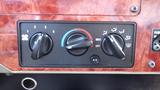 A close-up of the climate control panel with four dials labeled from 1 to 4 for fan speed temperature control and airflow direction with an A/C switch