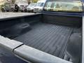 A 2008 Ford F-250 SD truck bed view showing a spacious and lined cargo area with no visible items inside