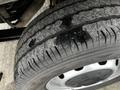 Close-up of a worn tire from a 2021 Ford Transit showing tread wear with visible dirt and debris on the surface