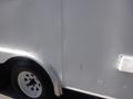 A 2004 Royal 18 Foot Office Trailer with a white exterior showing some minor dents and scratches near the wheels and entrance area