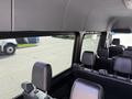 Interior view of a 2019 Mercedes-Benz Sprinter showing several black seats and a large window
