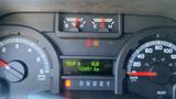 Dashboard display of a 2013 Ford Econoline showing gauges for fuel, temperature, and warning lights with a digital odometer reading 133851 km