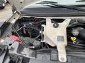 Engine compartment of a 2017 Chevrolet Express showing various components including the coolant reservoir battery and wiring