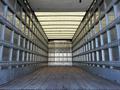 Interior of a 2016 Freightliner M2 106 truck with a spacious cargo area featuring wood flooring and metallic walls
