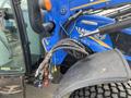 2016 New Holland T475 tractor with blue and yellow accents featuring hydraulic hoses and connectors attached to the front of the vehicle