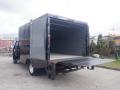 A 2017 Ford F-550 with an open box cargo area and a ramp for loading on the rear side