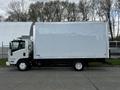 A 2022 Isuzu NPR box truck in white with a large empty cargo area on the back parked on a paved surface