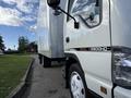 A 2007 GMC W5500 18 foot cube van parked with its white exterior and visible front cab with a black stripe bearing the model name W5500HD