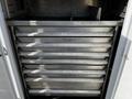 A 2018 Ford F-550 with a storage compartment featuring multiple metal drawers labeled with various tools and equipment