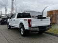 A white 2020 Ford F-350 Super Duty with a crew cab and FX4 off-road package parked on a pavement