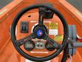 Close-up of the steering wheel and control panel of a 2008 Fassmer 20 Foot Fast Rescue boat with various buttons and switches for operation