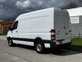 A white 2012 Mercedes-Benz Sprinter van features a high roof and boxy design with a rear cargo door and side windows