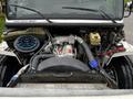 Close-up of the engine bay of a 2007 Freightliner M2 106 featuring a large air filter a cooling system a valve cover and various pipes and wires