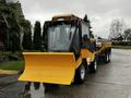 A yellow 2015 International 3000 MT6 snowplow with a large blade at the front and a trailer attached at the rear