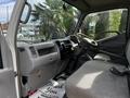 Interior view of a 2004 Toyota Toyoace with a gray seat and dashboard featuring controls and gear shift